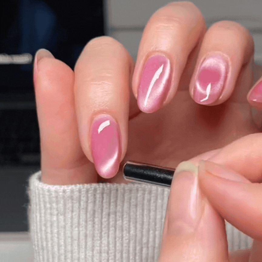 Glossy pink velvet nails using cat eye polish, the perfect manicure for Valentine's Day